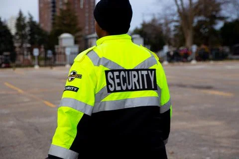 Security guard with caution tape to do parking enforcement at guest parking lot. Stock Photos