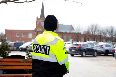 Security guard with caution tape to do parking enforcement at guest parking lot. 스톡 사진