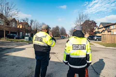 Security guard conducting access control and traffic control 库存照片