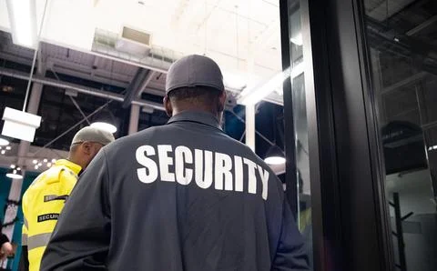 Security guard conducting access control and traffic control Stock Photos