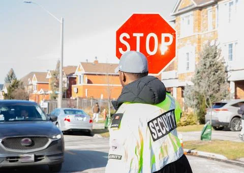 Security guard conducting access control and traffic control Stock Photos