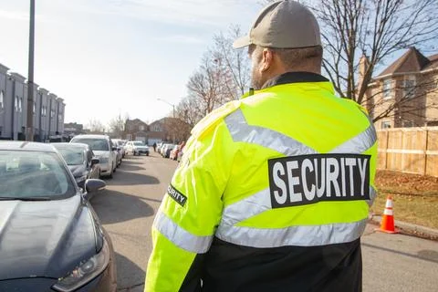 Security guard conducting access control and traffic control Stock Photos