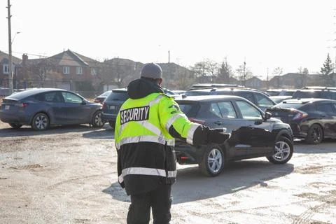 Security guard conducting access control and traffic control Stock-Fotos