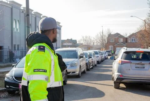 Security guard conducting access control and traffic control 스톡 사진