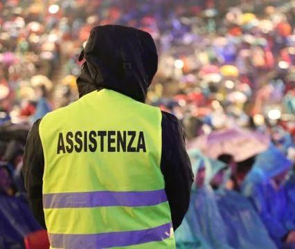 Security guard during the event with text ASSISTENZA that means Assitance in  Stock Photos
