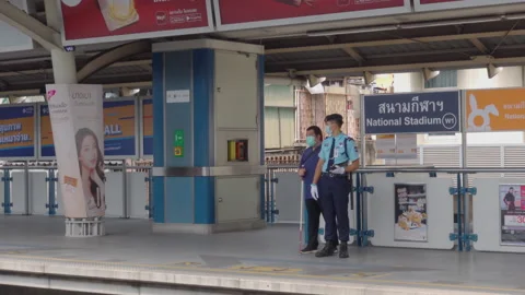Security Guard Helping Blind Man at Bangkok Sky Train Station Stock Footage 148229421