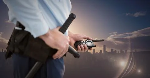Security guard lower body against skyline and sunset Foto stock