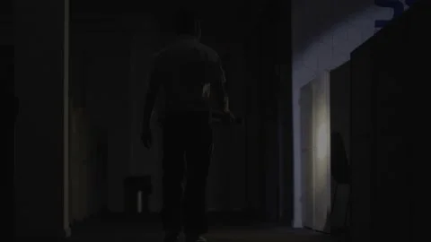 Security Guard makes a detour In Corridor Of The Building Using Flashlight Stock Footage 134502339