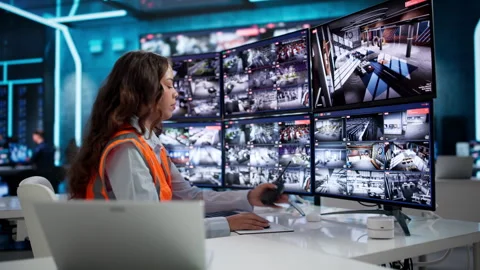 Security Guard Monitors Multiple CCTV Cameras Stock Footage 336375891