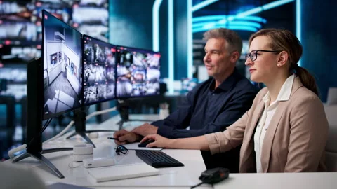 Security Guard Monitors Multiple CCTV Screens Closely Stock Footage 336791569