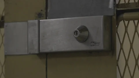 SECURITY GUARD OPENING PRISON DOOR Stock Footage 28040438