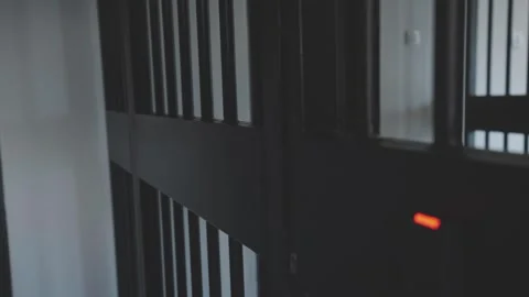 Security guard opens prison cell door bars in hallway crime justice interior. Stock Footage 337519250