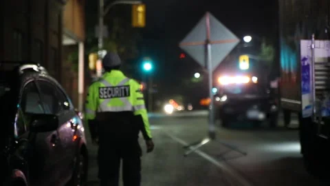 Security guard patrolling at construction site at night  city Stock Footage 202337315
