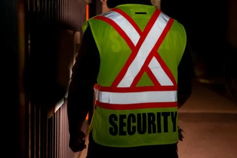 Security guard patrolling inside warehouse at night Stockfoto's