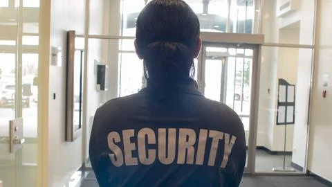 Security guard patrolling office space Stock Photos
