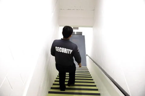 Security guard patrolling office space Фото