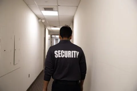 Security guard patrolling office space 库存照片