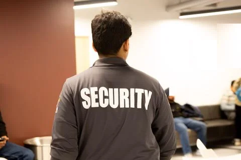 Security guard patrolling office space Stock Photos