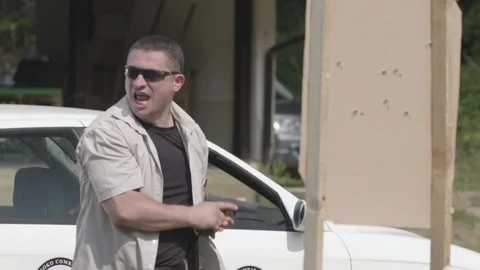 Security Guard Performing Action Self Defense With Gun Firing Against Attacker Stock Footage 116321457