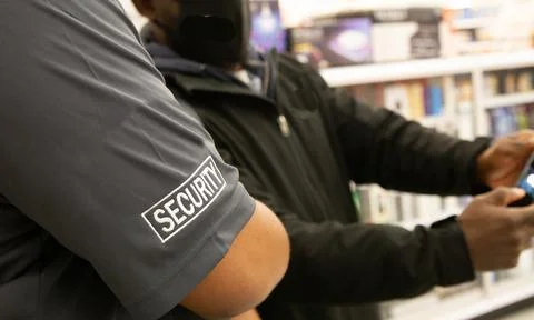Security guard recording information to share Stock Photos