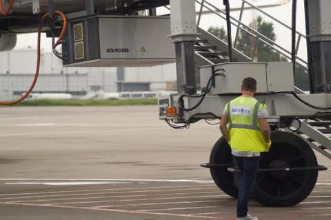 A security guard on the runway inspects the plane.Text-Security. Russia Stock Photos