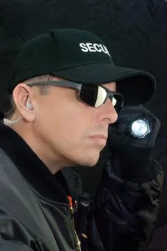 Security guard searches with flashlight Stock Photos