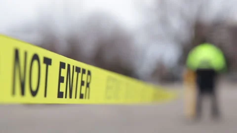 Security guard setting up a caution tape to do parking enforcement at guest park Stock Footage 233527601