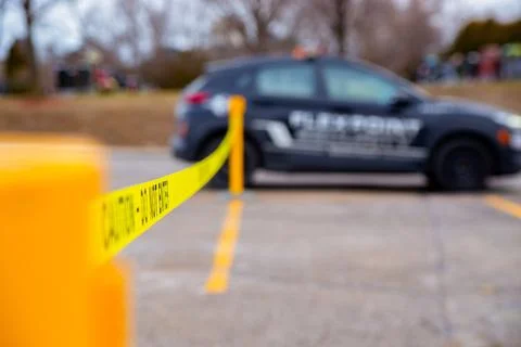Security guard setting up a caution tape to do parking enforcement at guest park Stockfoto's