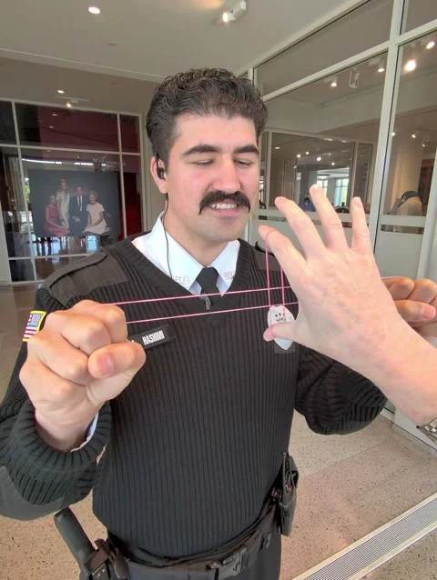 Security Guard Shocked By Rubber Band Magic Trick, Yorba Linda, California, USA  Stock Footage 330258003