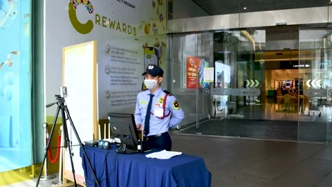 Security guard stand at walk through temperature screen checkup Stock Footage 150619866