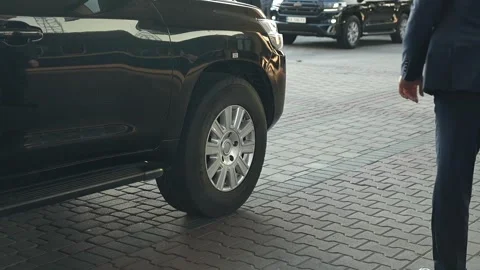 Security Guard Standing Next to an Armored SUV Stock Footage 344042592