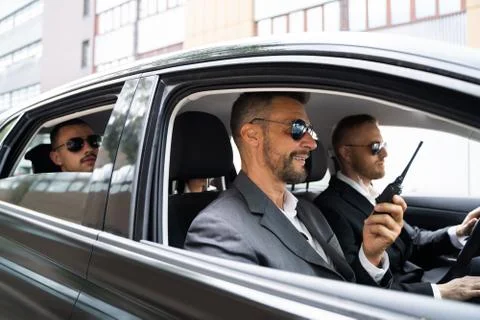 Security Guard In Sunglasses Inside Car Talking Stock Photos