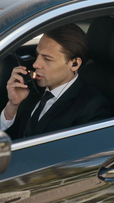 Security Guard Talking on Walkie Talkie While Sitting Inside Car Stock Footage 339411590