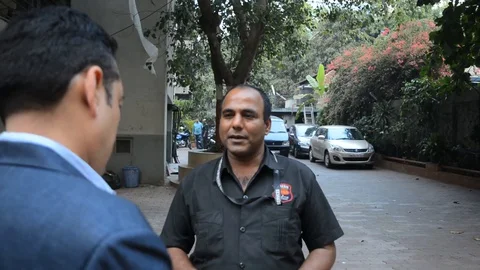 SECURITY GUARD TALKS TO VISITOR Stock Footage 130063249