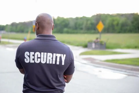 Security guard in uniform patrolling inside condo apartment Stockfoto's