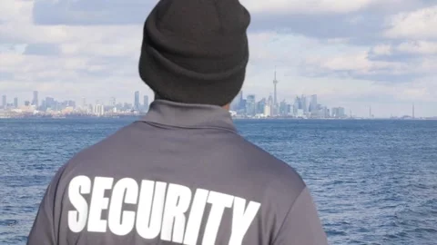 Security guard in uniform watching cityscape of Toronto Stock Footage 153888614