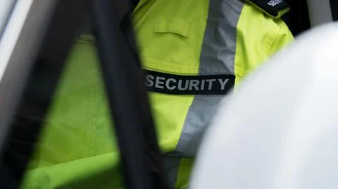 Security guard waiting inside security vehicle Stock Photos