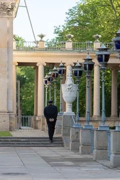 Security guard walking in historic palace park during safety patrol monitorin Stock Photos