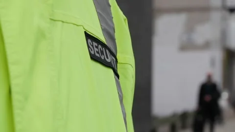 Security guard watching and patrolling street in city Stock Footage 153843298