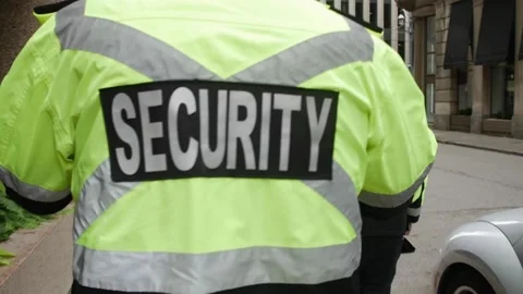 Security guard watching and patrolling street in city Stock Footage 153843317