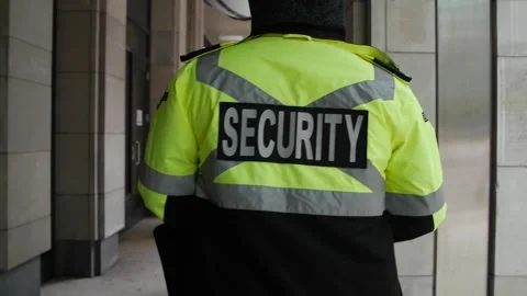 Security guard watching and patrolling street in city Stock Footage 153843336