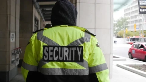 Security guard watching and patrolling street in city Stock Footage 153843343