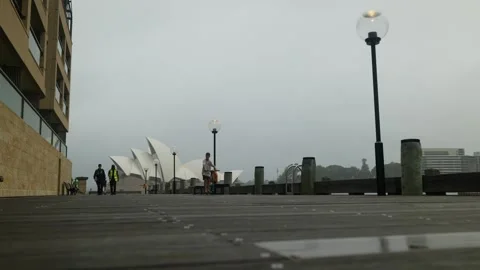 Security guards and boy on scooter Sydney Opera House 6K Stock Footage 302536699