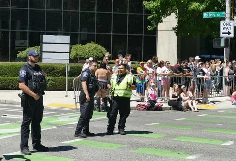 Security guards and policeman controlling people watching and cheering a pr.. Stock Photos