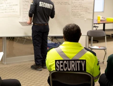 Security guards are learning how to use fire alarm panel Stock Photos