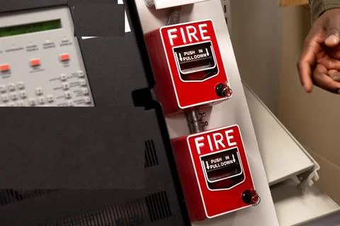 Security guards are learning how to use fire alarm panel Stock Photos