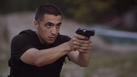 The security guards are trained to shoot guns at the shooting range. Stock Footage 95182034