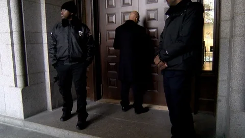 Security guards chain the doors shut during a travel-ban protest at Trump Int Stock Footage 125867827