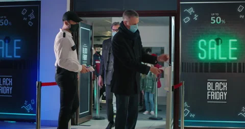 Security guards checking temperature of people in queue Stock Footage 143999303