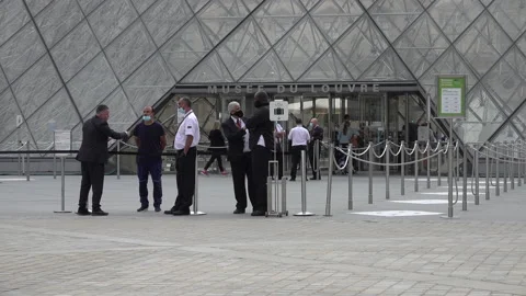 Security guards with face masks (coronavirus) at Louvre in Paris, France Stock Footage 139699387